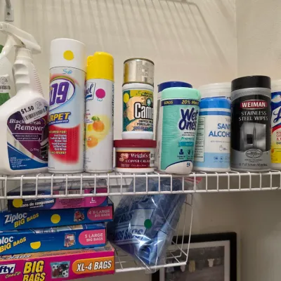 Sale Photo Thumbnail #262: Assorted household cleaning supplies, disinfecting wipes, and Ziploc storage bags arranged on wire closet shelving.