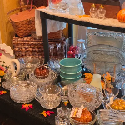 Sale Photo Thumbnail #44: Collection of vintage glass tableware, turquoise bowls, ceramic rooster pitcher, and decorative autumn items arranged on a table for sale.