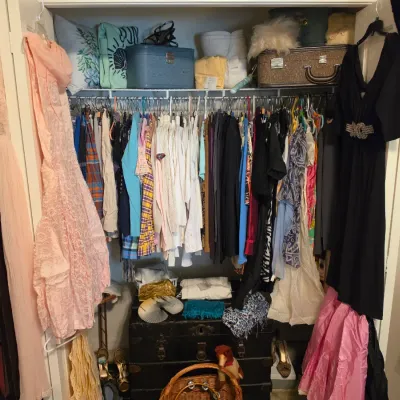 Sale Photo Thumbnail #195: Closet filled with vintage women's clothing, dresses, shoes, vanity cases, and a steamer trunk.