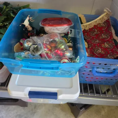 Sale Photo Thumbnail #303: Collection of plastic storage totes filled with holiday decor, including vintage Christmas ornaments, greenery garlands, and fabric stockings.
