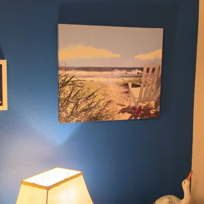 Sale Photo Thumbnail #181: Coastal-themed wall art collection including a canvas print of a beach scene with an Adirondack chair, a framed seashell collage, and a small sea turtle wall sculpture.