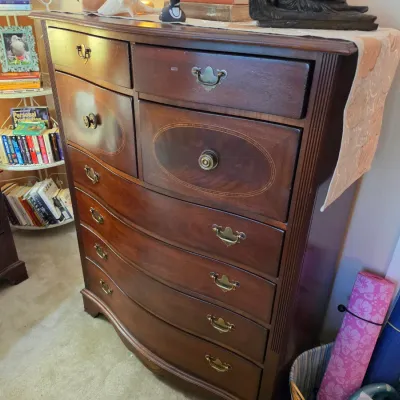 Sale Photo Thumbnail #137: Traditional dark mahogany tall chest of drawers with bow-front lower drawers, wood inlay details, and brass bail handles.