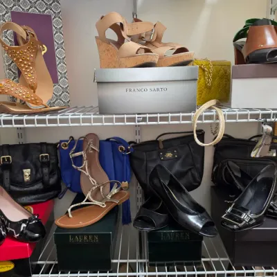 Sale Photo Thumbnail #158: Collection of women's designer shoes and handbags displayed on wire shelving, including items by Franco Sarto, Lauren Ralph Lauren, and Talbots.