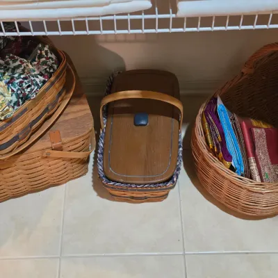 Sale Photo Thumbnail #68: Collection of vintage wicker and wood picnic baskets, Longaberger style, filled with colorful linens and fabrics.