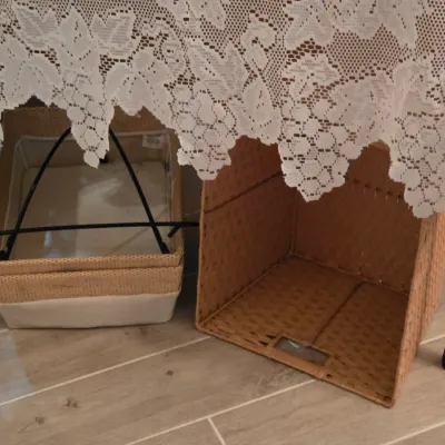 Sale Photo Thumbnail #8: Pair of woven storage baskets with canvas trim, stored underneath a lace table skirt.