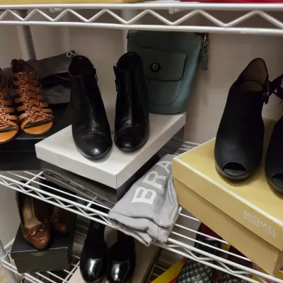 Sale Photo Thumbnail #150: Assortment of women's shoes and handbags on wire shelving, including Michael Kors, Coach, and Alfani brands.
