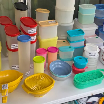 Sale Photo Thumbnail #320: Large collection of vintage Tupperware storage containers, pitchers, bowls, and strainers in various colors.