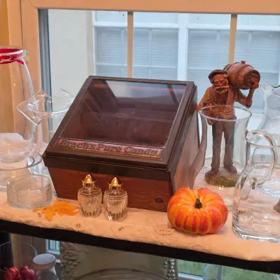 Sale Photo Thumbnail #45: Vintage Brach's Pure Candy wooden and glass display bin surrounded by clear glass pitchres, salt shakers, and a figurine.