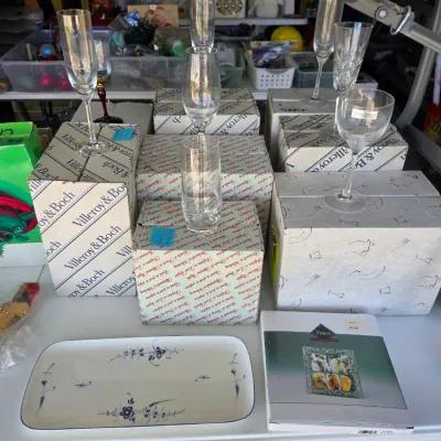 Sale Photo Thumbnail #309: Collection of crystal stemware including Villeroy & Boch pieces in boxes, alongside a blue floral porcelain tray and boxed Fetco photo frame.