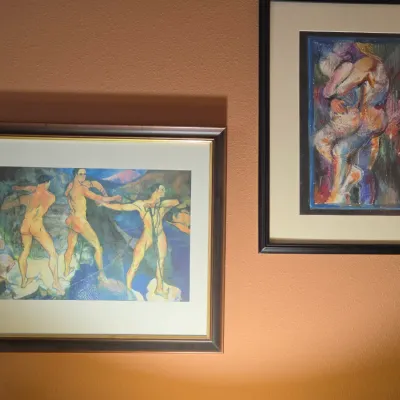 Sale Photo Thumbnail #109: Pair of framed figurative art prints displaying expressive male figure compositions in dark wooden frames.