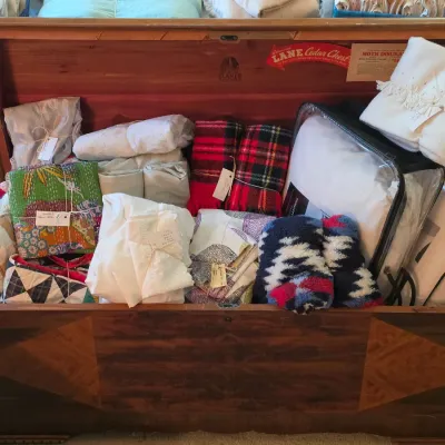Sale Photo Thumbnail #106: Vintage Lane cedar chest with two-tone veneer, filled with an assortment of linens, blankets, and textiles.