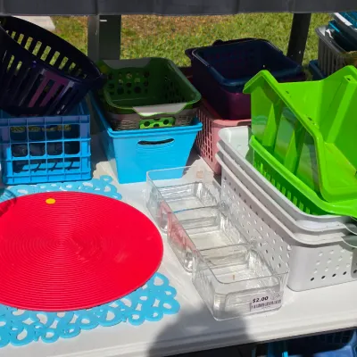 Sale Photo Thumbnail #331: Collection of plastic household organization items including various colorful storage bins, baskets, clear acrylic organizers, and silicone placemats.