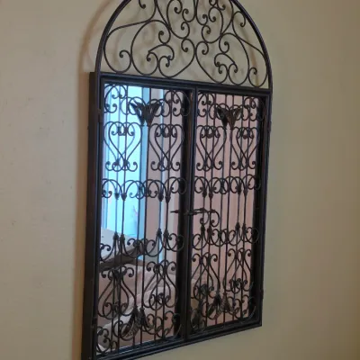 Sale Photo Thumbnail #95: Arched wall mirror with decorative black wrought iron scrollwork frame and faux window gate overlays.