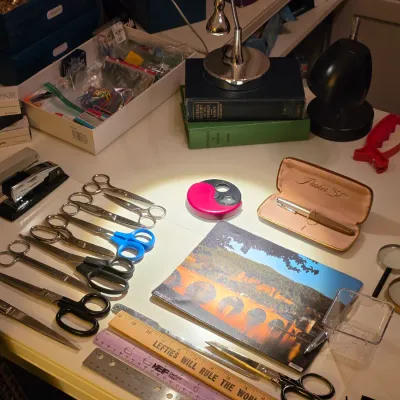 Sale Photo Thumbnail #242: Collection of vintage desk and office supplies, including a Parker '51' pen in case, various pairs of metal and plastic scissors, magnifying glasses, rulers, and staplers.