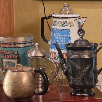 Sale Photo Thumbnail #10: Collection of vintage coffee and tea items, including an enamel Swedish coffee pot, silver-plated teapots, a glass French press, and a Maxwell House coffee tin.