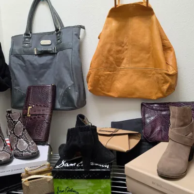 Sale Photo Thumbnail #147: Collection of women's fashion accessories including leather handbags, snakeskin-print booties, suede ankle boots, and wallets.
