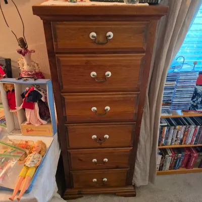 Sale Photo Thumbnail #126: Tall wood lingerie chest featuring six drawers with porcelain and brass pulls, displayed alongside vintage Barbie dolls and cases.