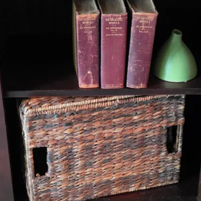 Sale Photo Thumbnail #88: Set of three vintage hardbound Victor Hugo's Works Sterling Edition books displayed on a shelf with a small green pottery vase and a woven storage basket.