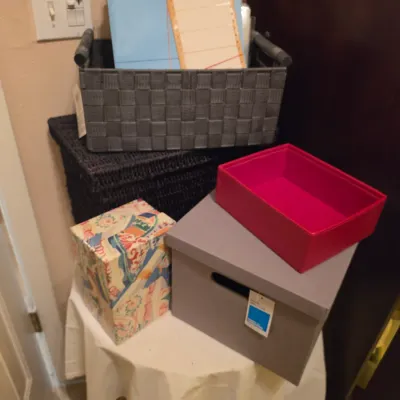 Sale Photo Thumbnail #233: Assortment of modern storage containers, including woven baskets, cardboard storage boxes, and a fabric-lined organizer, in good condition.