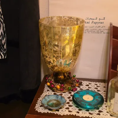 Sale Photo Thumbnail #248: Gold mercury glass hurricane goblet vase featuring a decorative beaded berry ring around the base.
