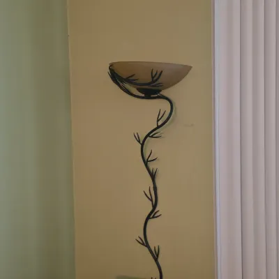 Sale Photo Thumbnail #96: Contemporary wrought iron floor lamp with a vine-like stem and frosted amber glass torchiere shade.