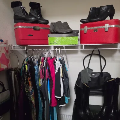 Sale Photo Thumbnail #161: Closet organization shelf displaying women's boots, ankle boots, vintage red Train cases, hanging activewear, and leather handbags.