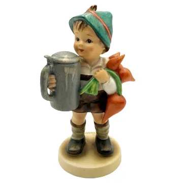 Vintage Goebel Hummel porcelain figurine depicting a young boy in traditional lederhosen holding a steingut mug and carrots.