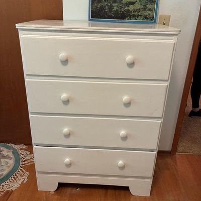Sale Photo Thumbnail #12: White painted four-drawer wooden dresser with matching round knobs.