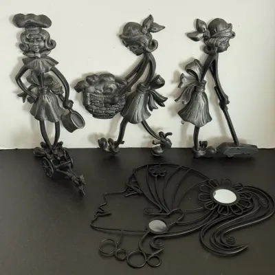 Set of vintage vintage-style metal wall decor, including three stylized figures performing household chores and a wireframe woman's...