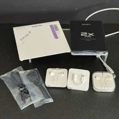 Lot of computer accessories including a Sony 2X FDD external floppy drive, Samsung external optical drive, Apple EarPods, Lightning audio...
