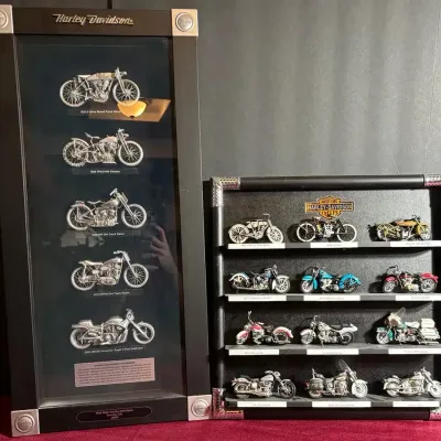 Two framed Harley-Davidson shadow box collections featuring detailed miniature motorcycle models from various historical eras.
