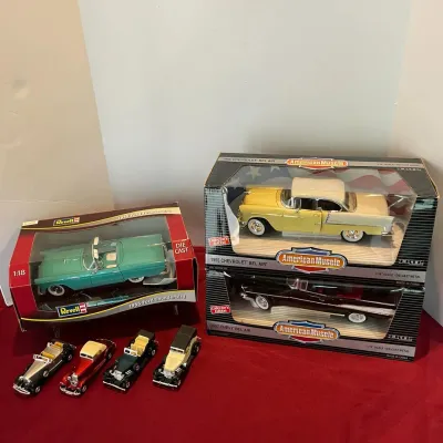 Collection of die-cast model cars, featuring boxed 1:18 scale models including a Revell 1955 Ford Thunderbird, Ertl American Muscle 1955...