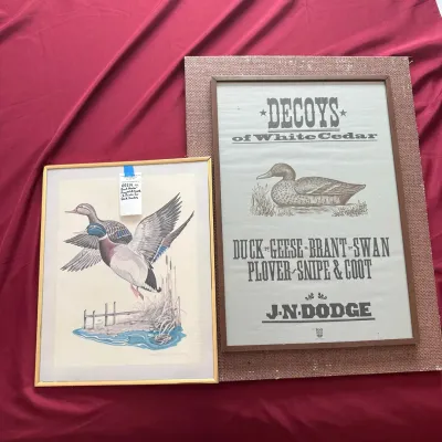 Two framed waterfowl-themed art pieces, including a color illustration of flying ducks and a vintage-style 'Decoys of White...