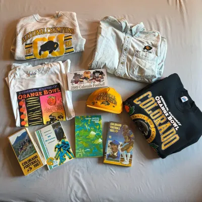 Collection of vintage University of Colorado Buffaloes football memorabilia, including 1990 National Champions sweatshirts, Orange Bowl...