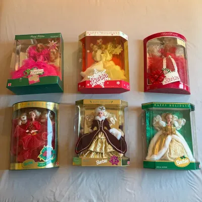 Sale Photo Thumbnail #106: Collection of six vintage 1990s Mattel Happy Holidays Special Edition Barbie dolls, new in their original packaging.