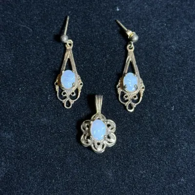 Sale Photo Thumbnail #109: Vintage opal jewelry set, including a pair of filigree drop earrings and a matching pendant.