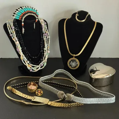 Collection of vintage costume jewelry and accessories including multi-strand beaded necklaces, a headdress ornament, a gold-tone pendant...