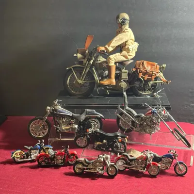 Collection of die-cast and scale model motorcycles, including a large vintage WWII G.I. Joe style military motorcycle with figure rider.