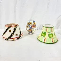 Sale Photo Thumbnail #191: Collection of three decorative ceramic jar candle toppers and accessories, including floral and green apple patterned pieces.