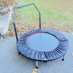 Sale Photo Thumbnail #262: Mini fitness rebounder trampoline featuring a black safety pad skirt and a detachable stability handlebar.