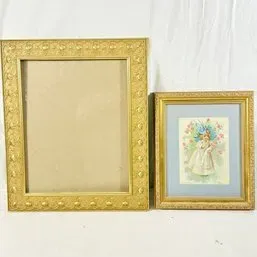Sale Photo Thumbnail #99: Pair of gilded vintage frames, including a larger empty frame with raised relief detailing and a smaller frame featuring a matted Victorian-style print of a young girl.