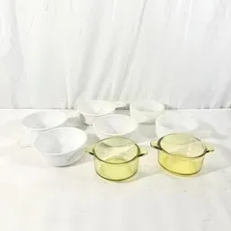 Sale Photo Thumbnail #163: Collection of vintage glass cookware and bowls, including white Corning Ware grab-it bowls and yellow Visions glass casserole dishes.