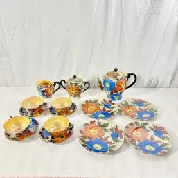 Sale Photo Thumbnail #120: Vintage hand-painted Japanese lusterware tea set featuring vibrant orange and blue floral motifs, including teapot, creamer, sugar bowl, cups, and saucers.