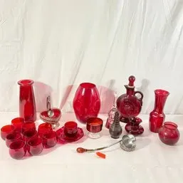 Sale Photo Thumbnail #162: Collection of vintage ruby red glassware, including vases, decanters, small cups, and a decorative ladle.