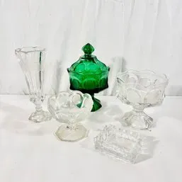 Sale Photo Thumbnail #101: Collection of vintage glassware items including a green Moon and Star covered candy dish, clear pedestal bowls, a bud vase, and a small dish.