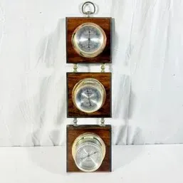 Sale Photo Thumbnail #92: Vintage three-tier wall-hanging weather station featuring a barometer, thermometer, and hygrometer set into square wood mounts.