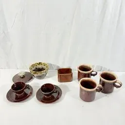 Sale Photo Thumbnail #59: Collection of mid-century brown ceramic tableware, including espresso cups with saucers, coffee mugs, a small dish, and a lava glaze bowl.