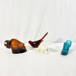 Sale Photo Thumbnail #138: Collection of decorative glass and ceramic figurines, including an amber glass bison, ruby red glass bird, miniature white bear, and turquoise glass shoe.