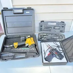 Sale Photo Thumbnail #24: Collection of power tools and socket sets in hard plastic cases, including a pneumatic finish nailer and soldering gun kit.