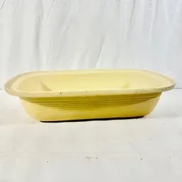 Sale Photo Thumbnail #63: Vintage yellow Fiesta baking dish with concentric ring detailing along the exterior sides.